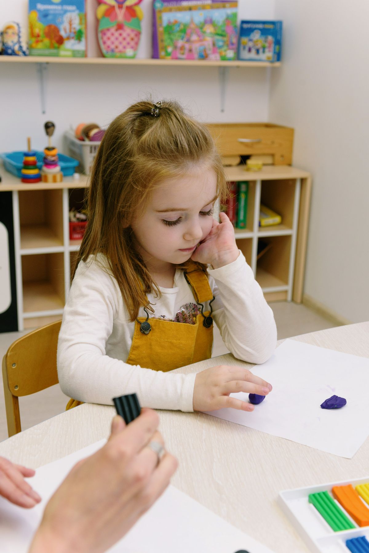 Child practicing speech sounds with flashcards during a home speech-therapy session